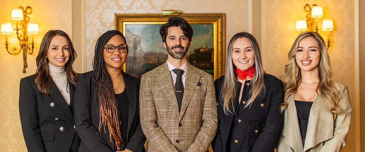 Group of professionals posing in elegant setting.