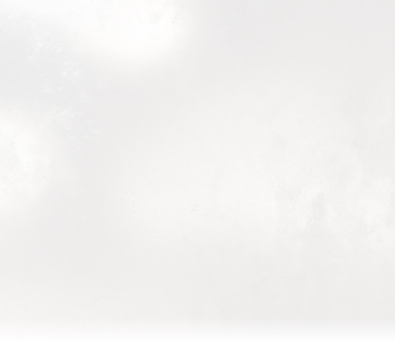 Abstract white textured background with slight gradient.