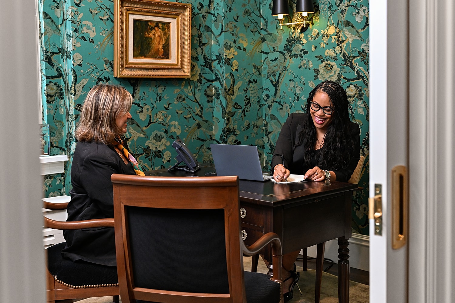 Two women engaged in a business discussion.