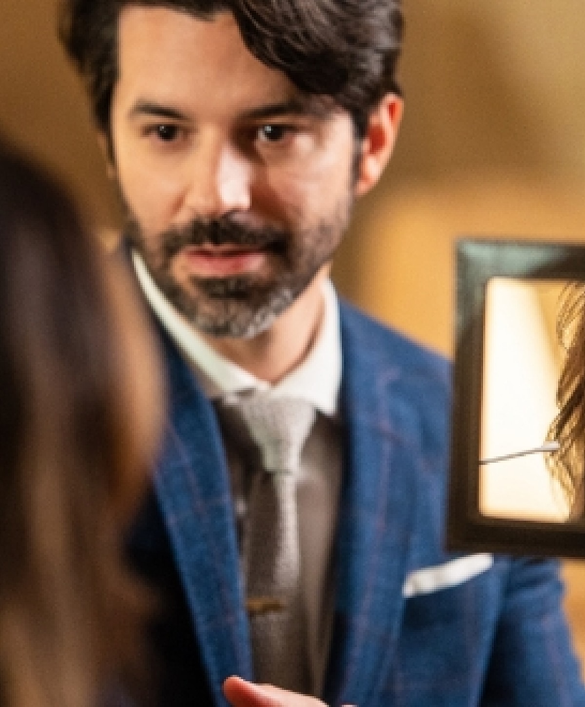 Man talking while looking in a mirror.