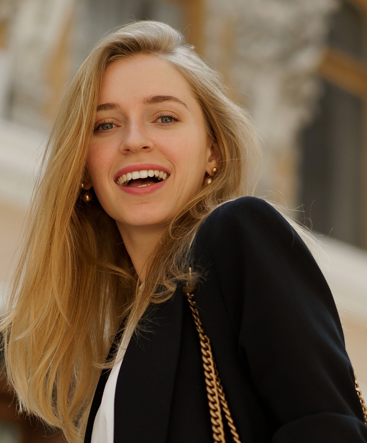Smiling woman with long hair and blazer.