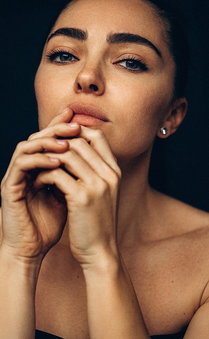 Close-up of a woman with thoughtful expression.