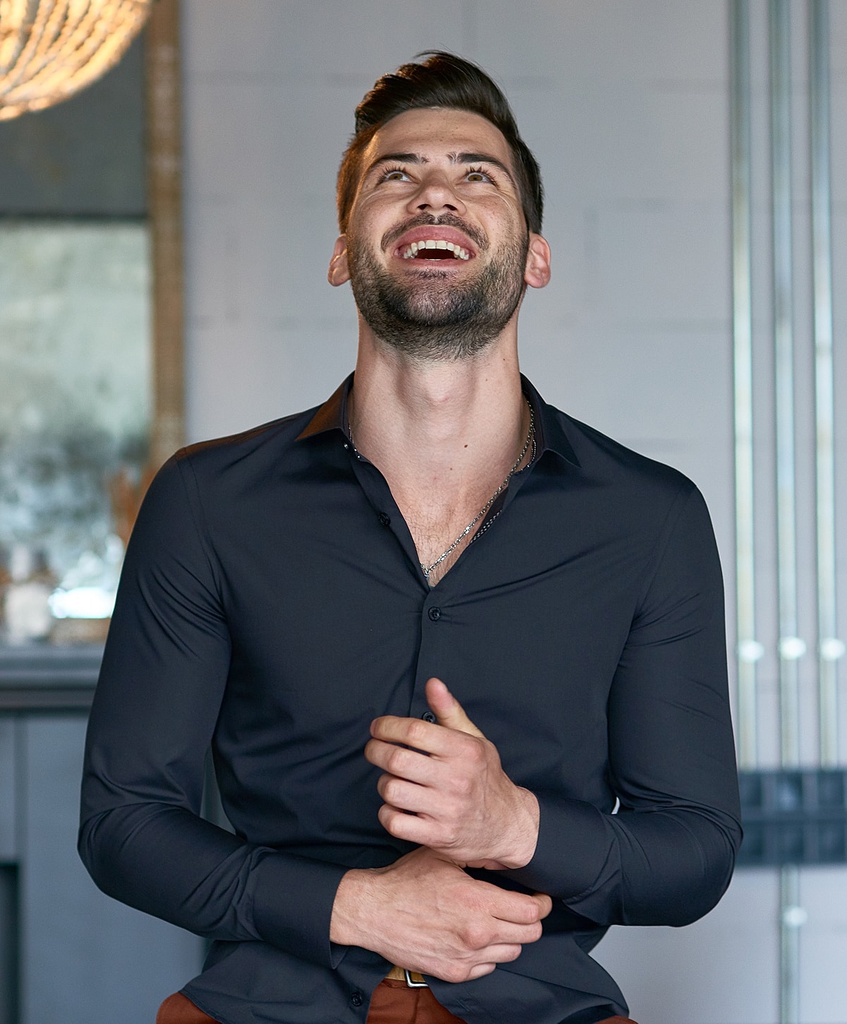 Smiling man in a stylish black shirt.