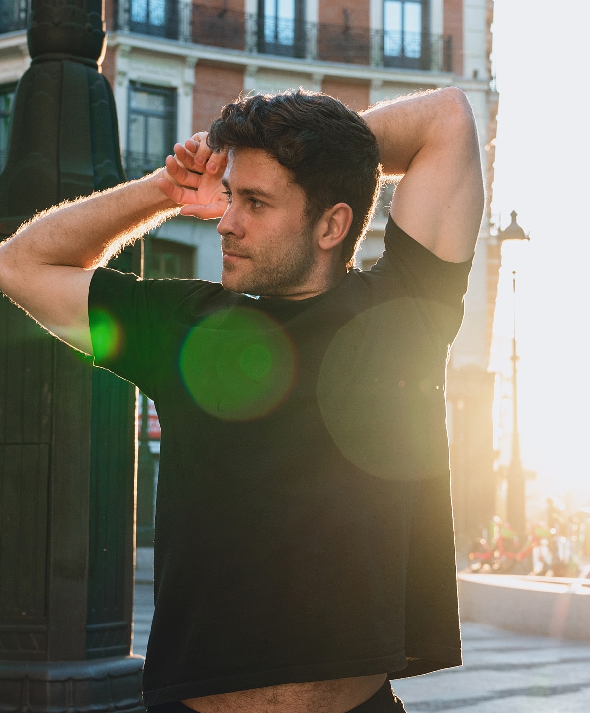 Man stretching in warm sunset light.