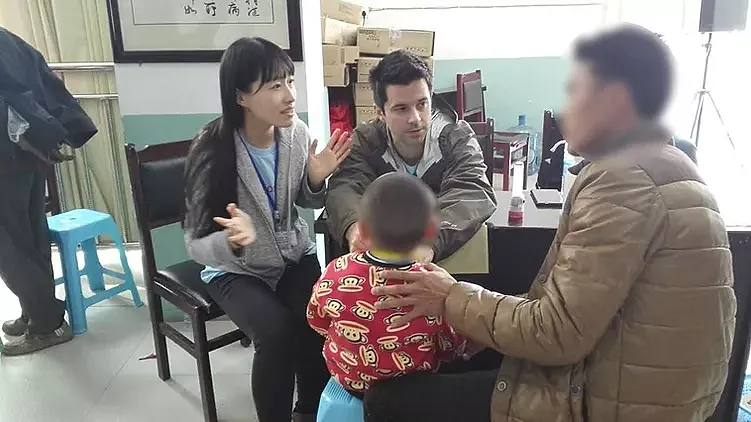 Discussion between adults and child in indoor setting.