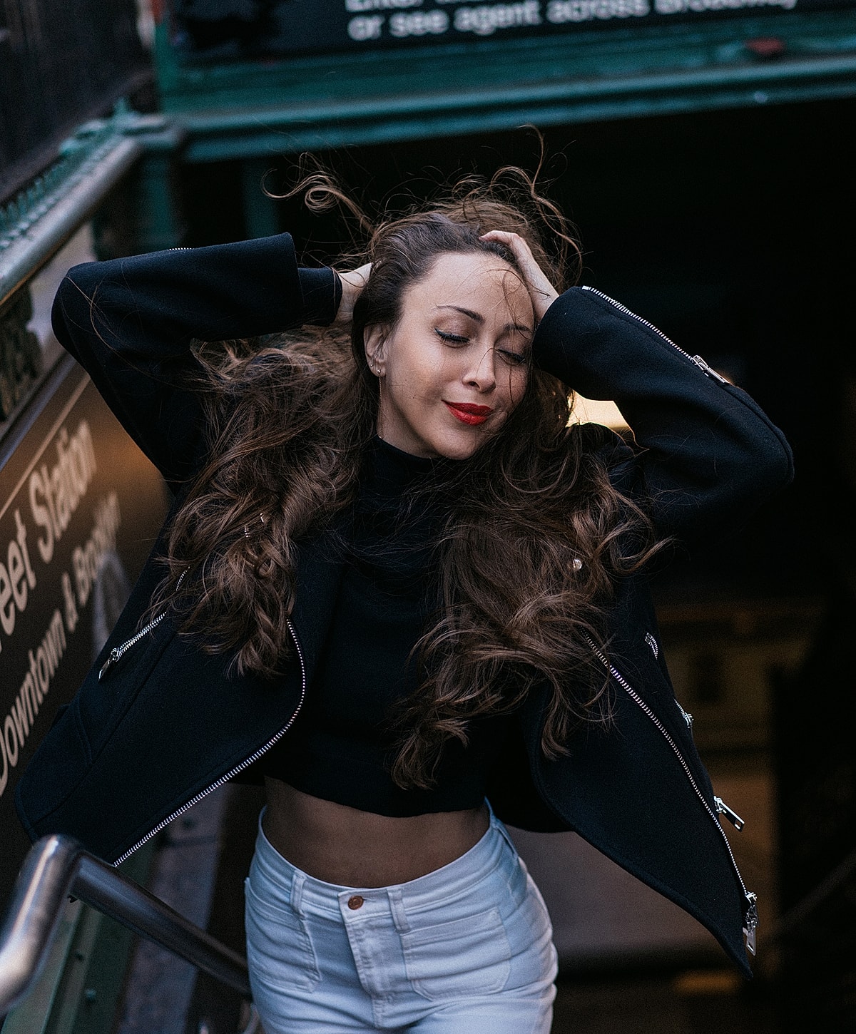Woman with flowing hair in urban setting.