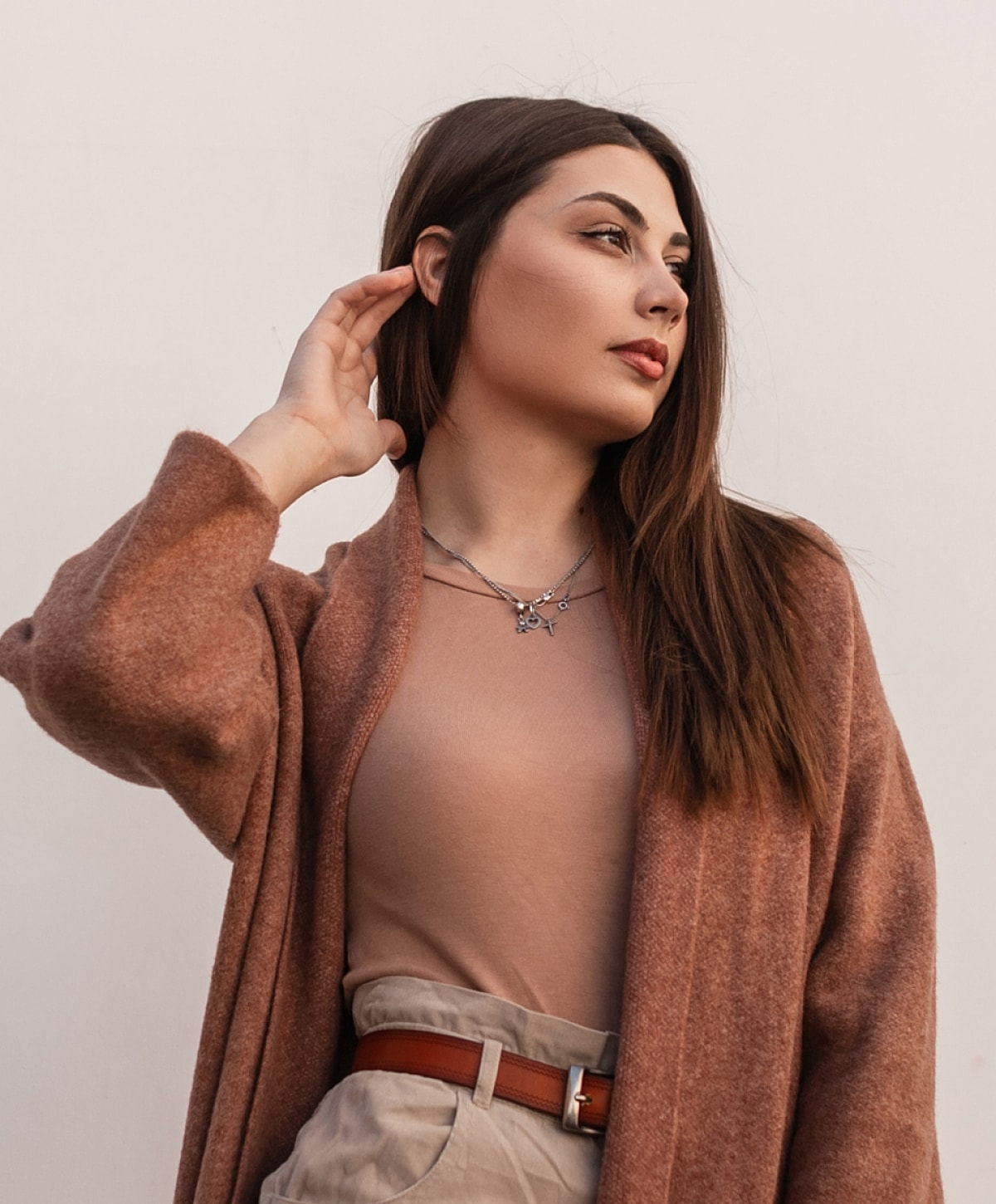 Woman in stylish outfit posing confidently.