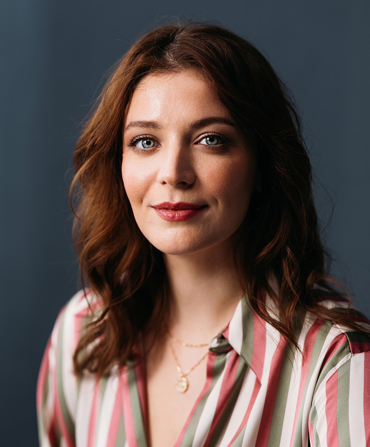 Portrait of a woman with wavy brown hair.