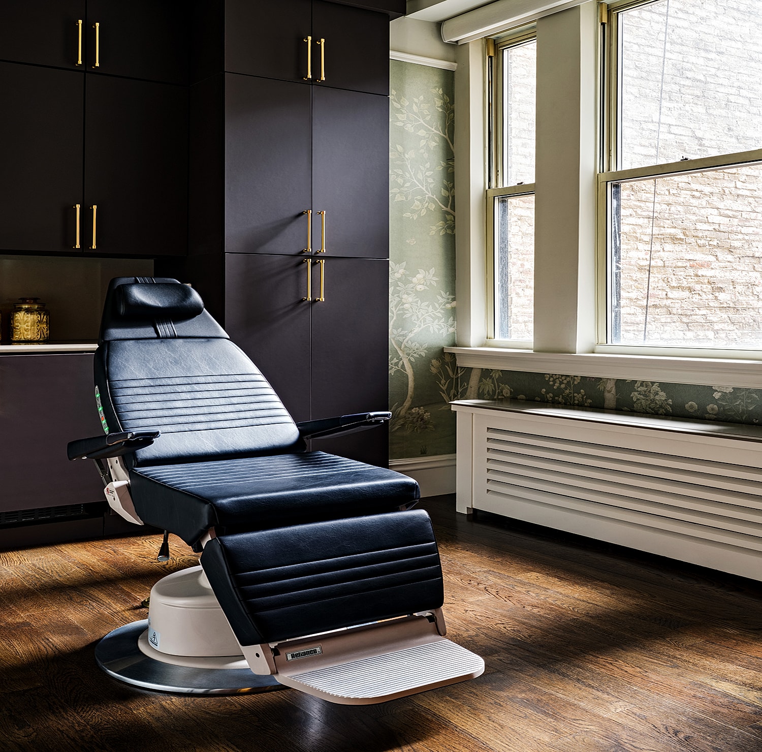 Modern black treatment chair in stylish interior.
