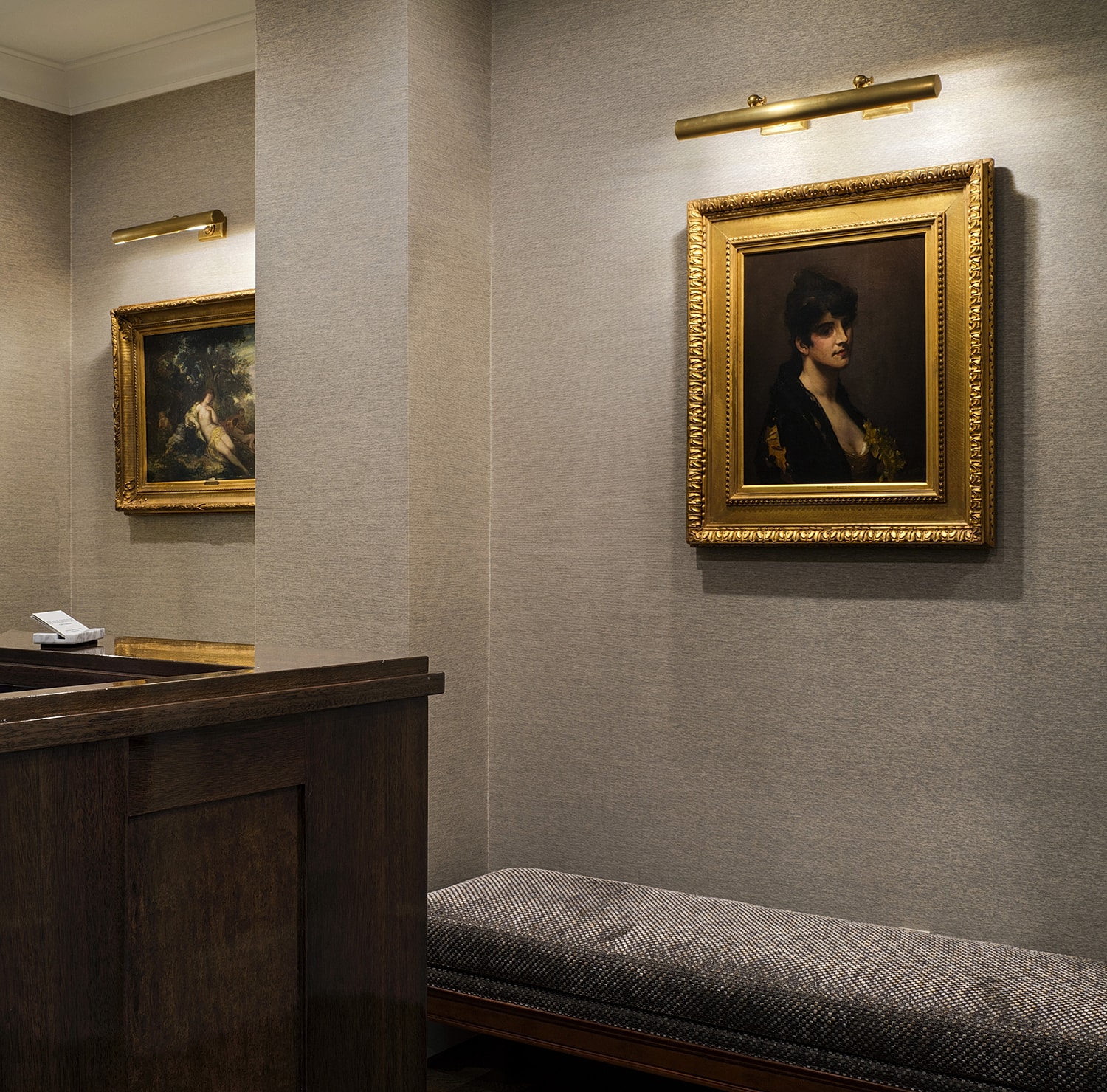Elegant interior with framed artwork and seating.