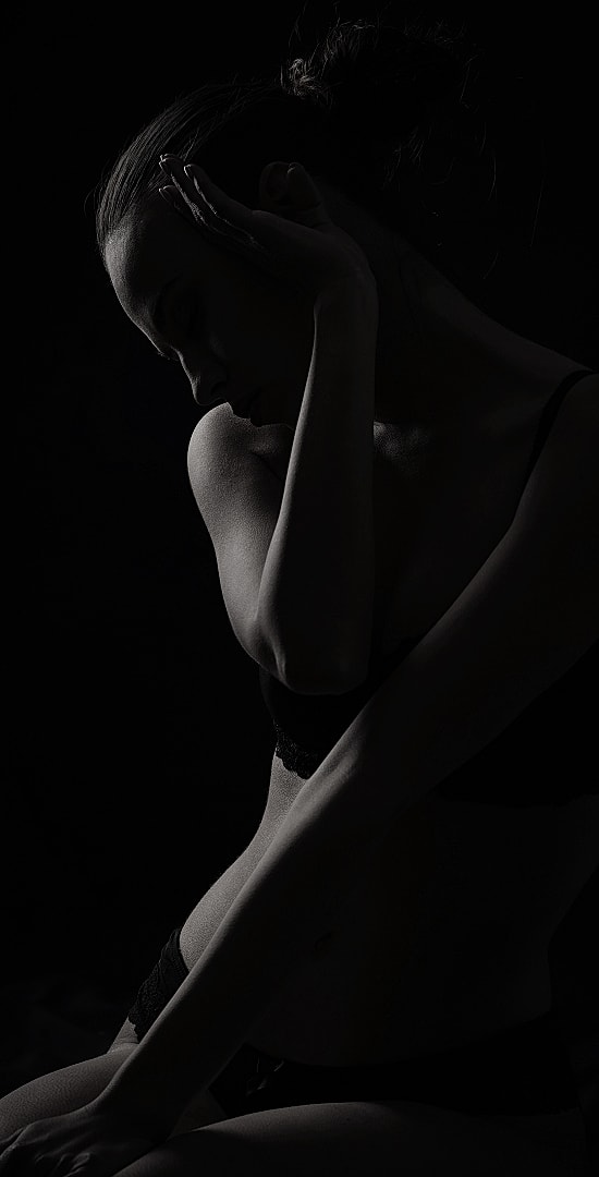 Silhouette of a woman in low light.