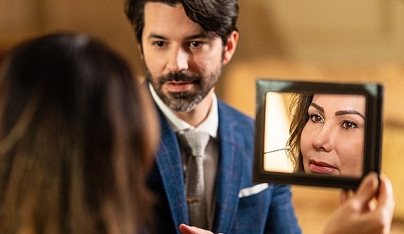 Couple reflecting on emotions through a mirror.