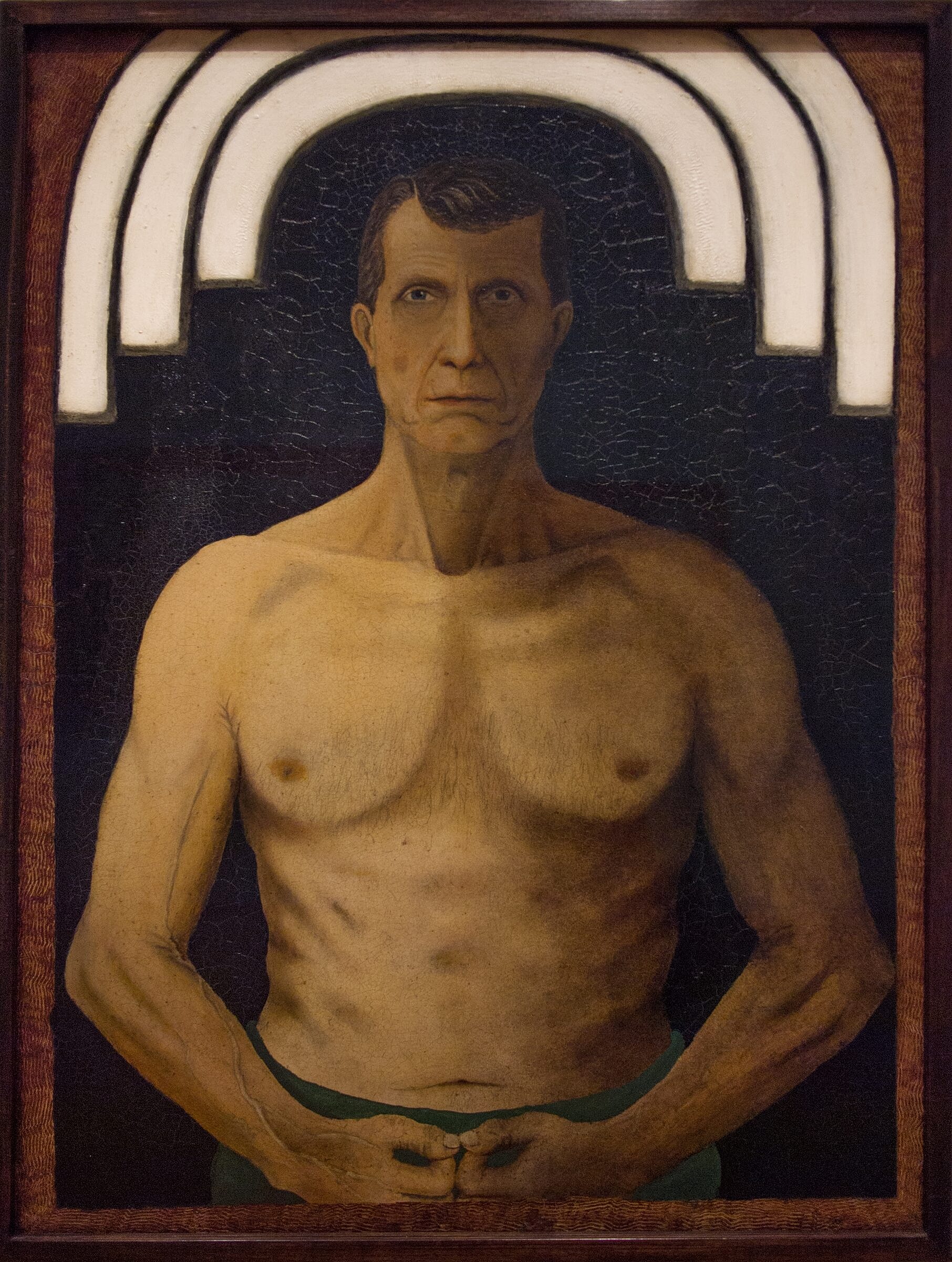 Portrait of a shirtless man with serious expression.